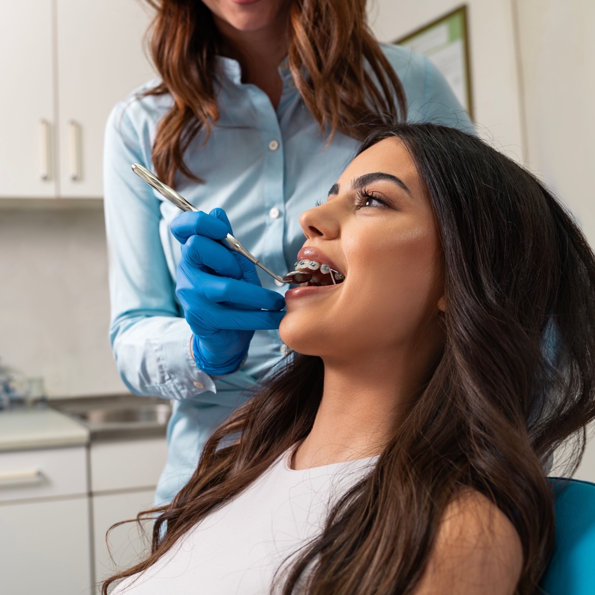 A dental braces patient with her dentist